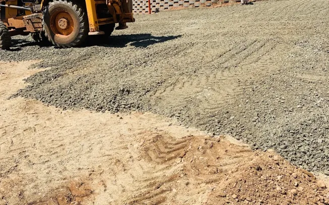 A compacted G5 stone sub-base spread and rolled over the shaped earth, before any asphalt is laid.